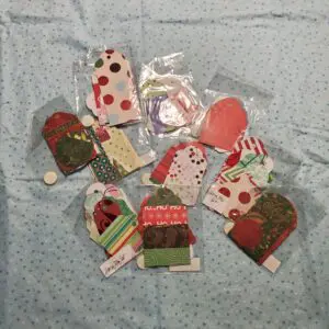 Colorful holiday gift tags arranged on a blue surface.