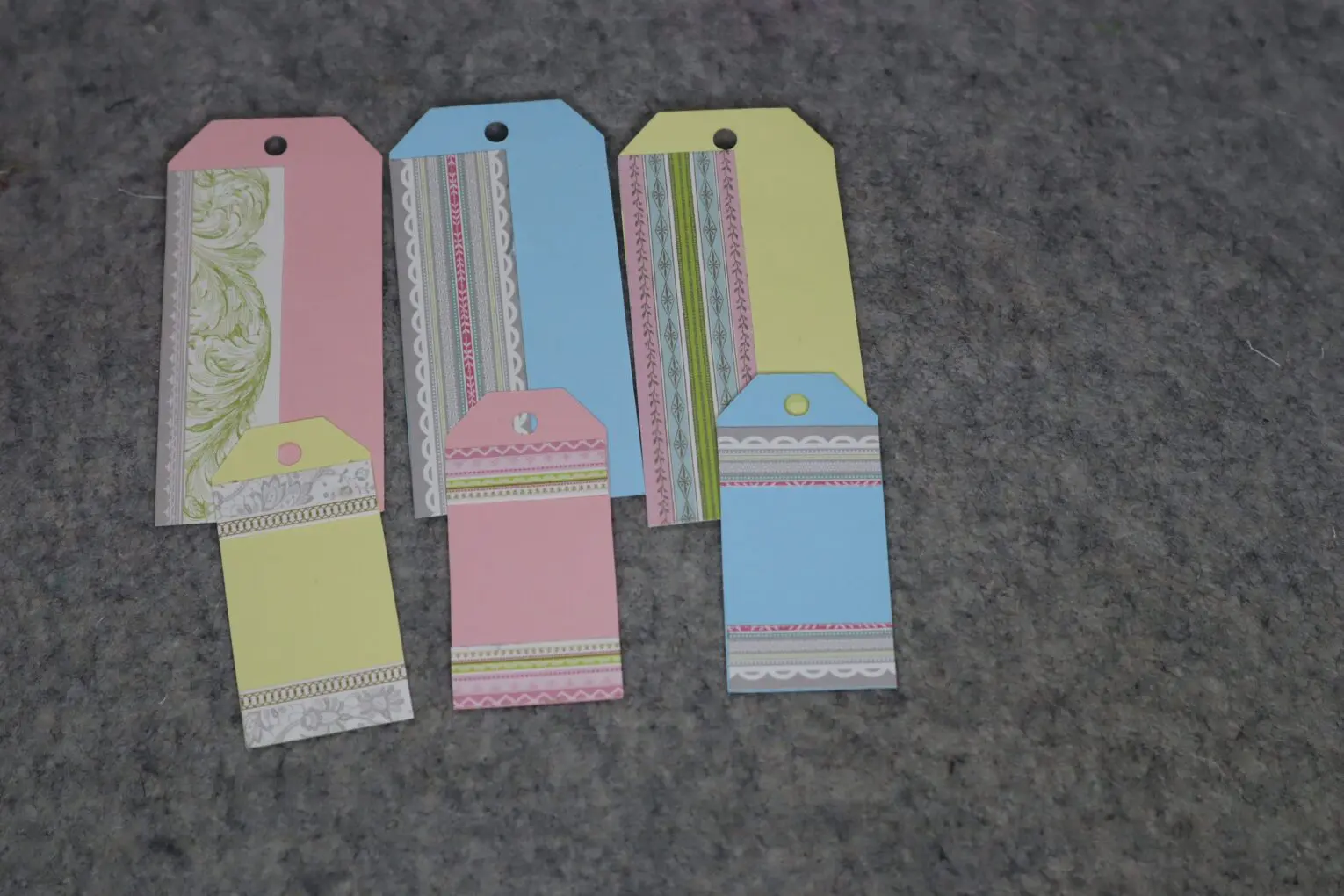 Colorful decorative tags arranged on a gray surface.
