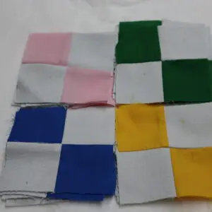 Four fabric pieces with checkered patterns in different colors.