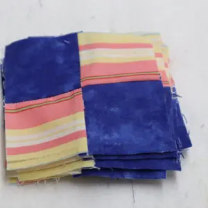 Folded fabric with blue and striped pastel colors.