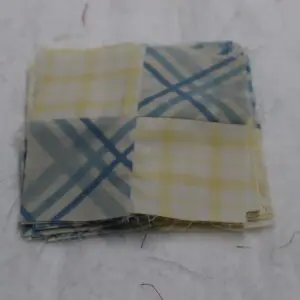 Folded checkered cloth with blue and yellow patterns.