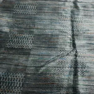 Close-up of a woven fabric with a checkered pattern in muted colors.
