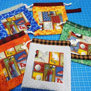 Colorful fabric pouches with windowed panels displaying intricate patterns.