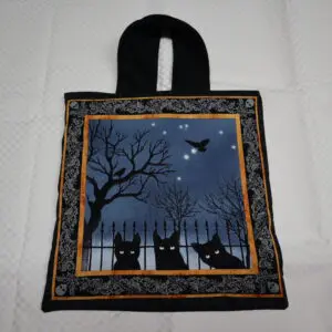 Halloween-themed tote bag with spooky cats and bats design.