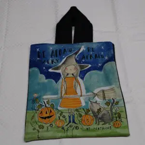 Halloween-themed fabric bag with cartoon animals and pumpkins.