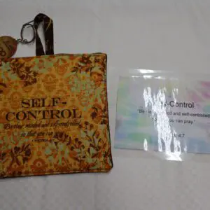 A decorative pouch labeled 'SELF-CONTROL' and a small card with an inspirational message.