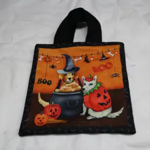 Halloween-themed tote bag with pumpkins, a witch, and festive decorations.