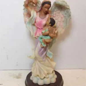 Angel figurine holding a child, symbolizing protection and care.