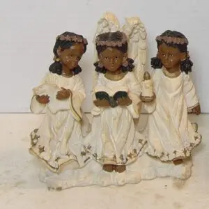 Three angel figurines holding musical instruments and a book.