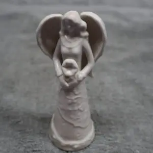 A small angel statue holding a child figure.