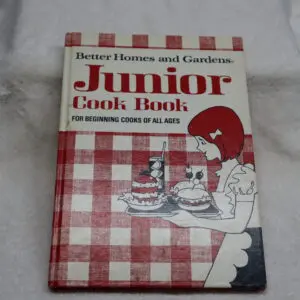 Vintage Junior Cook Book with red checkered cover and cartoon chef illustration.