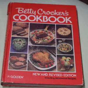 A vintage Betty Crocker's Cookbook with various dish photos on the cover.