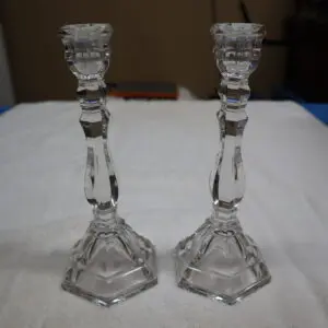 Pair of elegant crystal candlesticks with intricate designs.