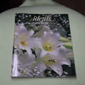 Book titled 'Idealis Flowers' with white lilies on the cover.