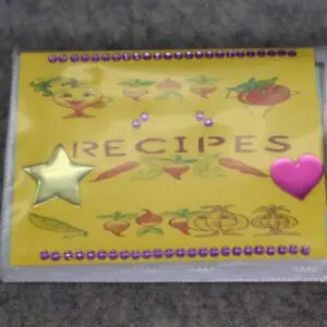 Decorative recipe book cover with colorful designs and stars.