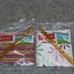 Two packaged Revive brand cloth products with different colorful patterns.