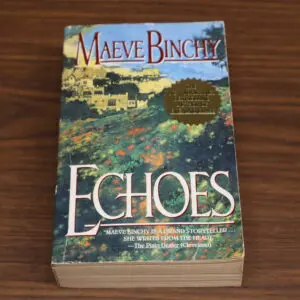 A paperback copy of Maeve Binchy's novel 'Echoes' on a wooden surface.