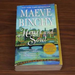 Book titled 'Heart and Soul' by Maeve Binchy on a wooden surface.