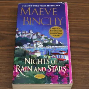 Book cover of Maeve Binchy's "Nights of Rain and Stars" with a coastal village illustration.