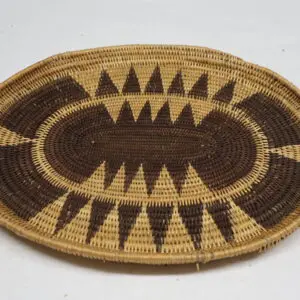 Oval woven basket with triangular geometric patterns.