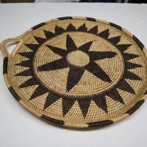 Round woven basket tray with star pattern and handles.