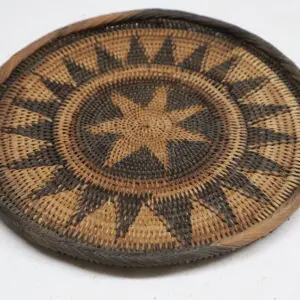 Intricately woven basket with star and sunburst design.