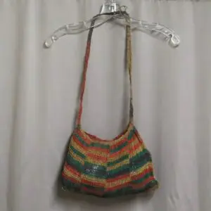 Colorful striped shoulder bag hanging on a clear hanger.