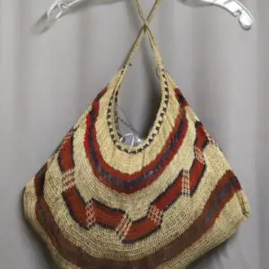 Handmade crochet bag with multicolored stripes and unique shape.