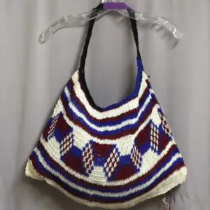 Colorful handcrafted knitted handbag with geometric patterns.