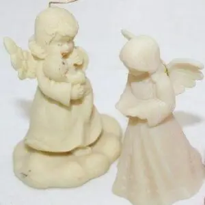 Two delicate porcelain angel figurines with soft pastel colors.
