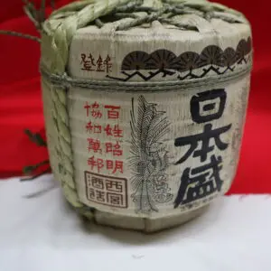Traditional Japanese sake barrel with kanji writing.