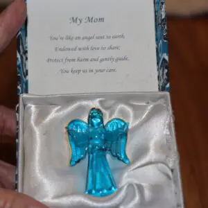 Blue angel ornament in a box with a sentimental note titled 'My Mom'.