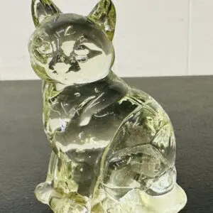 A transparent glass cat figurine with intricate details.