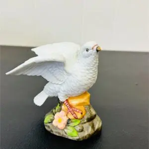 Porcelain white dove figurine on a floral base.