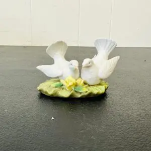 Porcelain figurine of two white doves on a floral base.