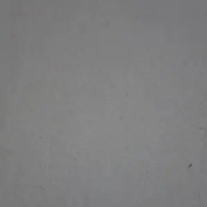 A plain gray concrete wall surface.
