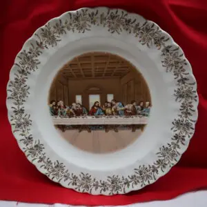 Decorative plate featuring The Last Supper artwork with floral border.