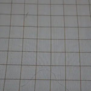 Close-up of a grid drawn on paper.