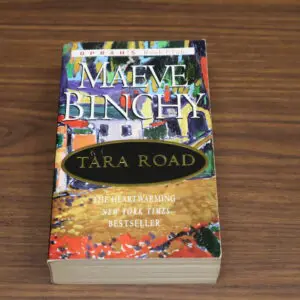 Maeve Binchy's novel 'Tara Road' on a wooden surface.