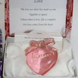 Pink heart-shaped trinket with sentimental inscription.