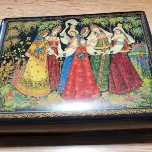 Decorative box featuring traditional women in colorful dresses.