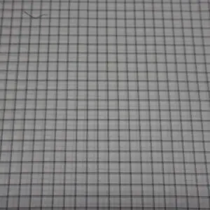 Grid pattern on a white surface with black lines.