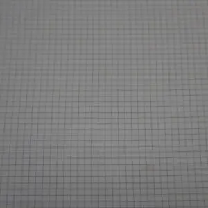 Close-up of graph paper with a grid pattern.