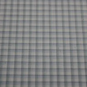 Close-up of a checkered fabric pattern with light and dark squares.
