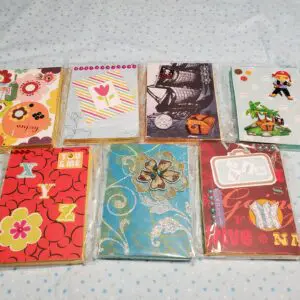 Colorful notebooks with decorative designs displayed.
