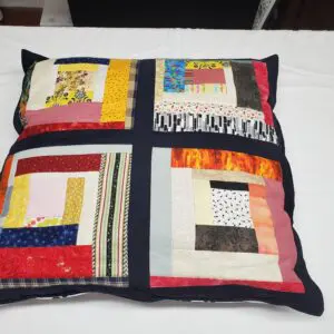 Colorful patchwork pillow with black borders.