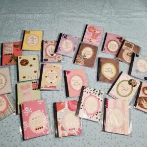 Colorful greeting cards arranged on a blue surface.