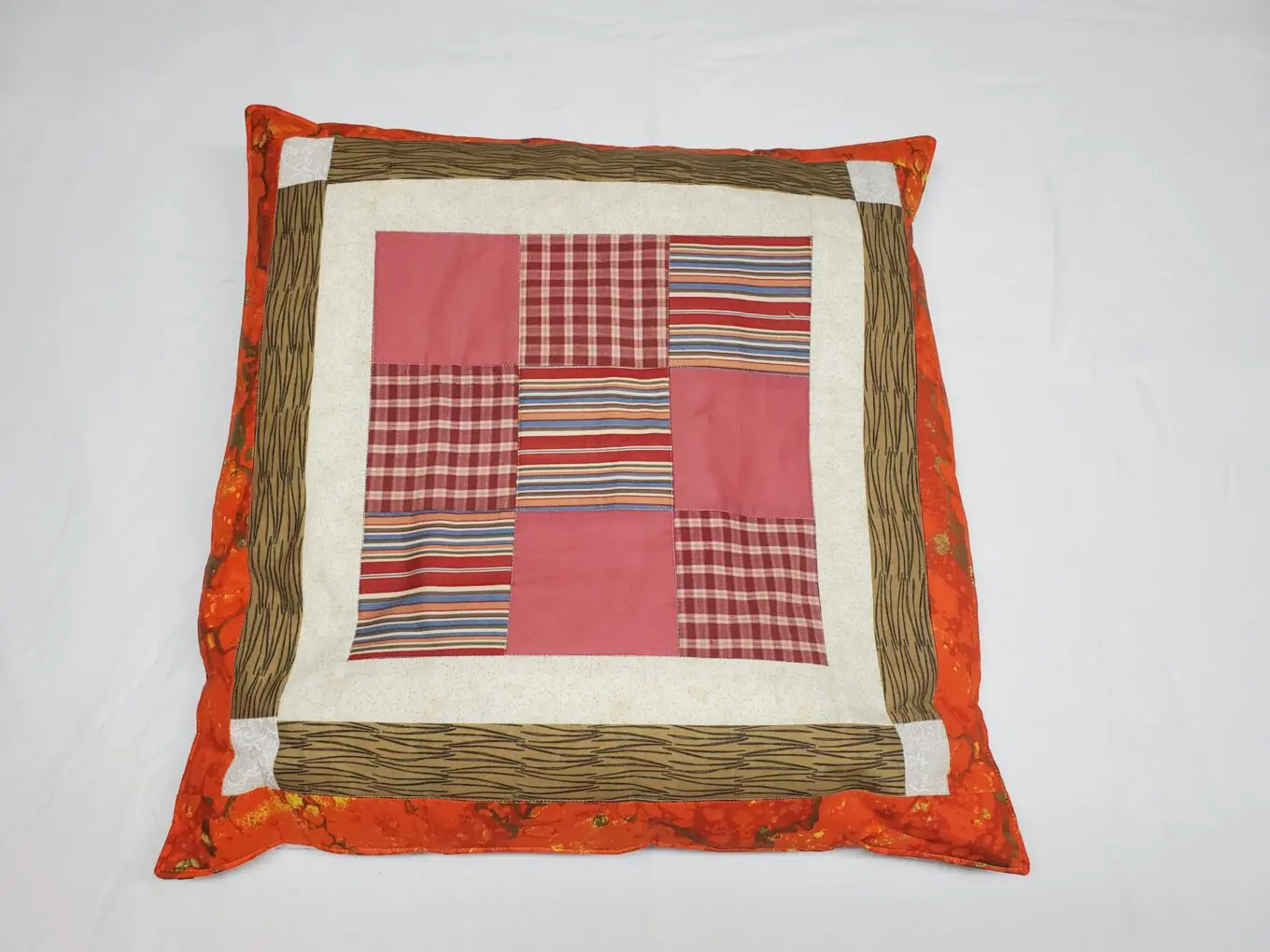 Colorful patchwork cushion with paw prints