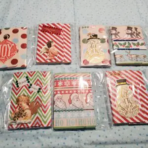 Colorful holiday-themed notebooks arranged on fabric.