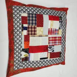 Colorful patchwork pillow with red trim